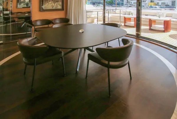 The separate dining area with a round table and windows